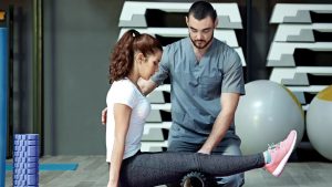 Lady going through PT exercise with a Physical Therapist.